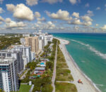 Miami Beach city with high luxury hotels and condos and sandy beachfront.